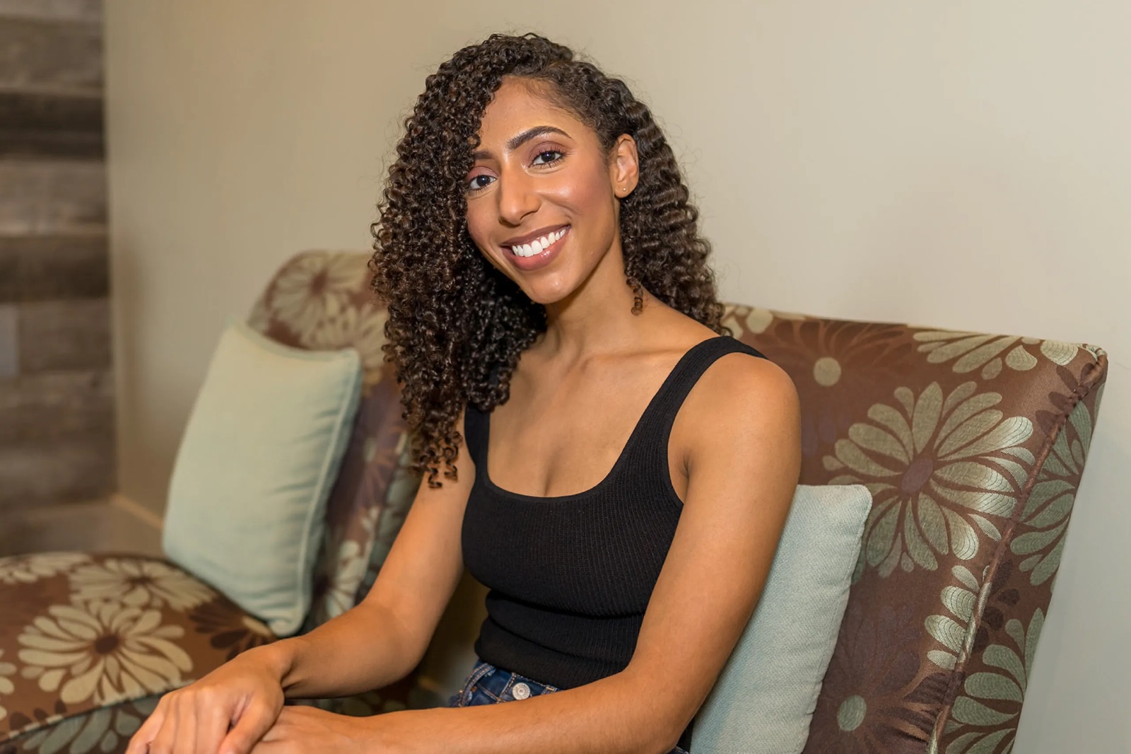 A beautiful black woman in black shirt smiling